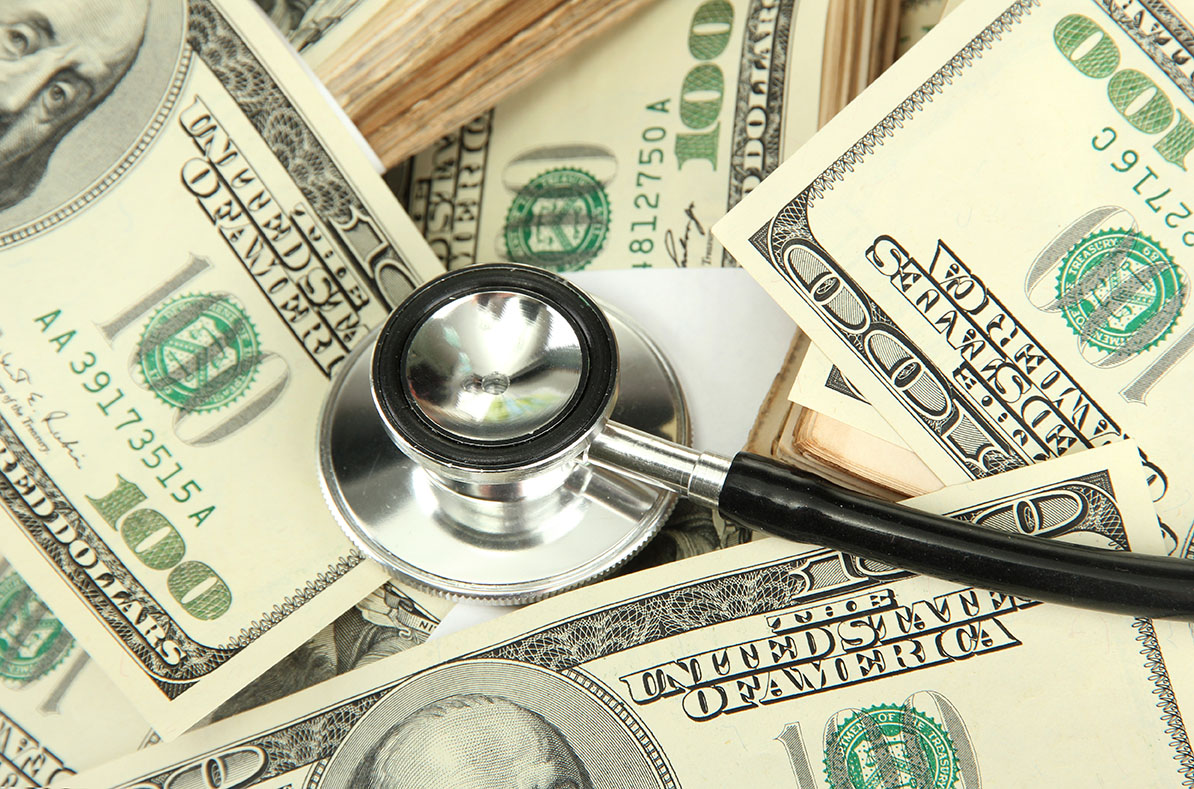 Healthcare cost concept: stethoscope and dollars background